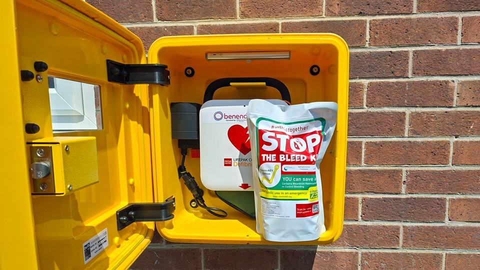 Open Defibrillator Cabinet showing the new Bleed Kit placement
